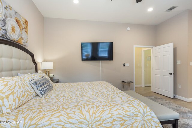 bedroom with recessed lighting, wood finished floors, visible vents, and baseboards