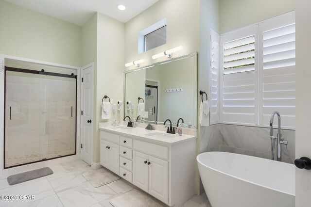 full bathroom with double vanity, a stall shower, a sink, a freestanding bath, and marble finish floor