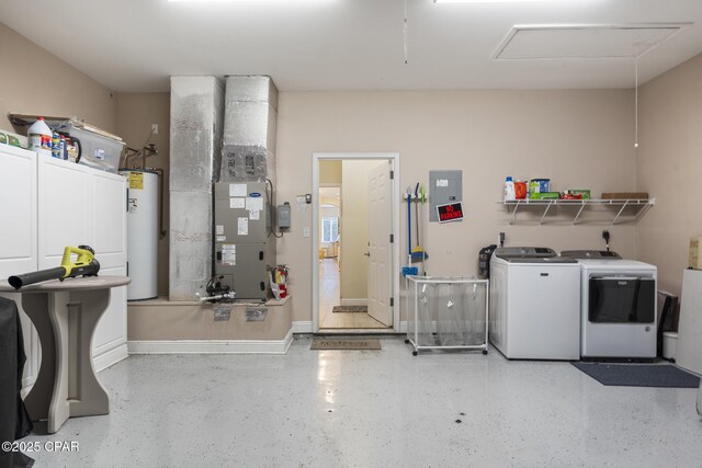 garage featuring washer and dryer, baseboards, heating unit, and water heater