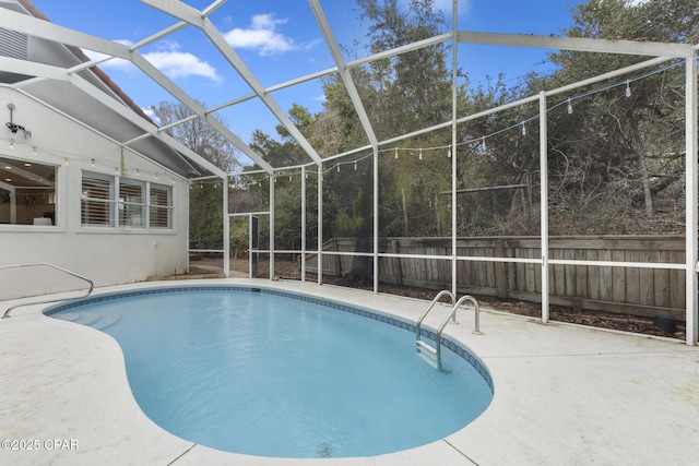 view of swimming pool with a fenced in pool, glass enclosure, a patio, and fence