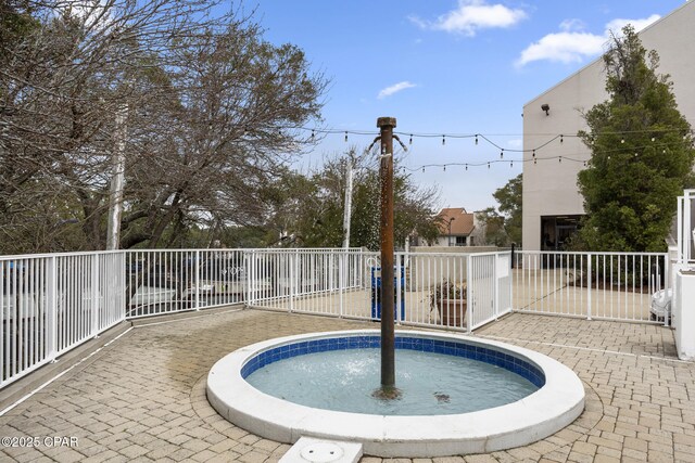 view of swimming pool featuring a patio area and fence