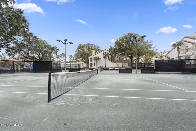 view of sport court featuring fence