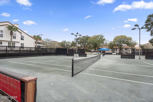 view of sport court featuring fence