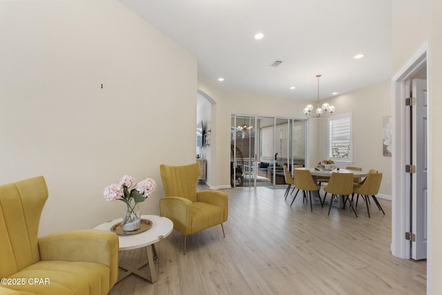 dining space with visible vents, baseboards, light wood-style flooring, recessed lighting, and arched walkways