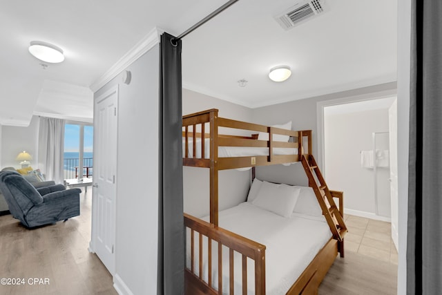 bedroom with wood finished floors, visible vents, access to exterior, baseboards, and ornamental molding