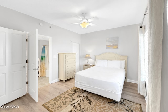 bedroom with light wood-style flooring, baseboards, and ceiling fan