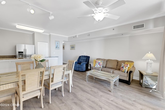 dining area with ceiling fan, ornamental molding, light wood-type flooring, and visible vents