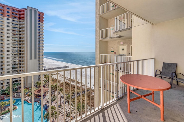 balcony featuring a water view and a view of the beach