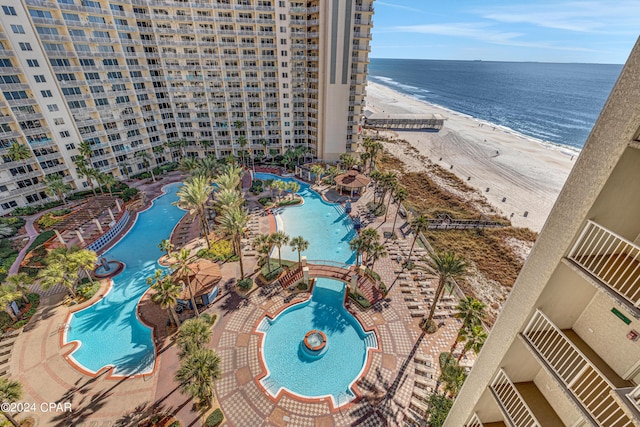 view of pool featuring a view of the beach and a water view