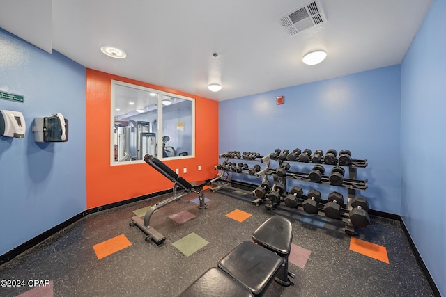 gym with baseboards and visible vents