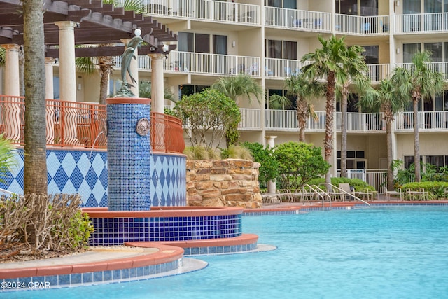 community pool with a pergola