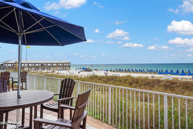 exterior space featuring a water view and a beach view