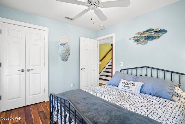 bedroom featuring ceiling fan, a closet, visible vents, and wood finished floors