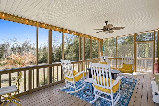 sunroom featuring ceiling fan