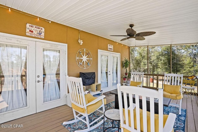 sunroom featuring a ceiling fan and french doors