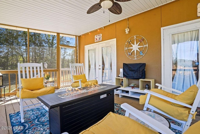 sunroom / solarium with ceiling fan, french doors, and wood ceiling