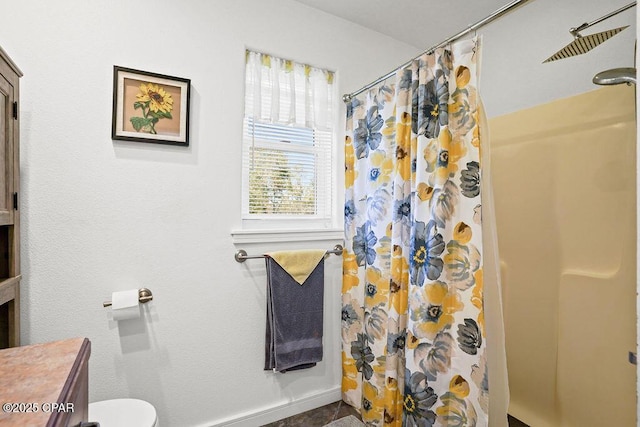 bathroom with toilet and curtained shower