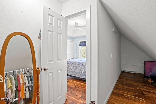 hallway with baseboards and wood finished floors