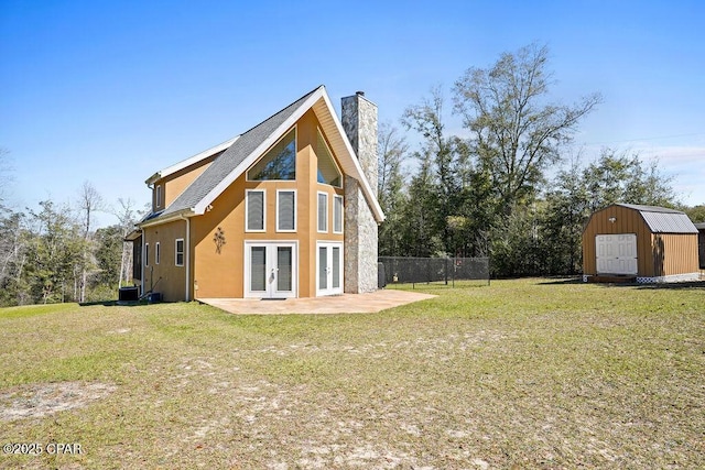 back of property featuring a patio, a storage shed, fence, french doors, and a chimney