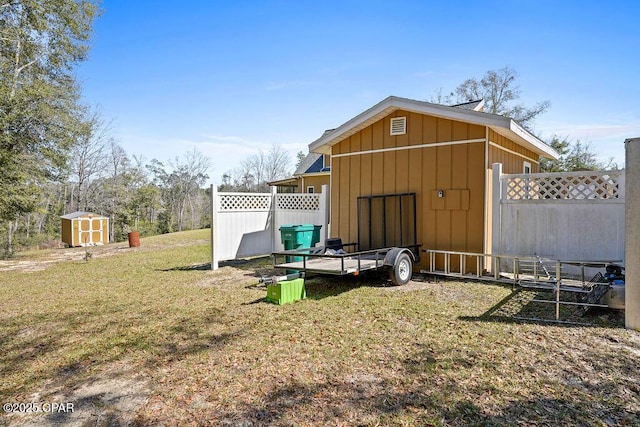 view of shed featuring fence