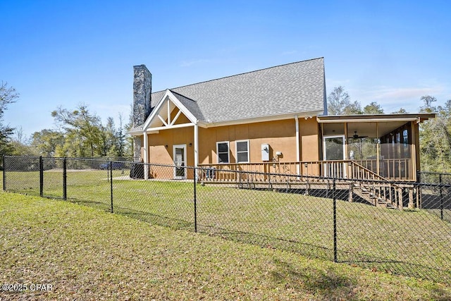 view of front of house with a chimney, a front yard, and a fenced backyard