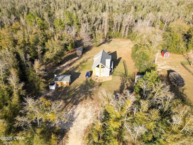 birds eye view of property with a view of trees