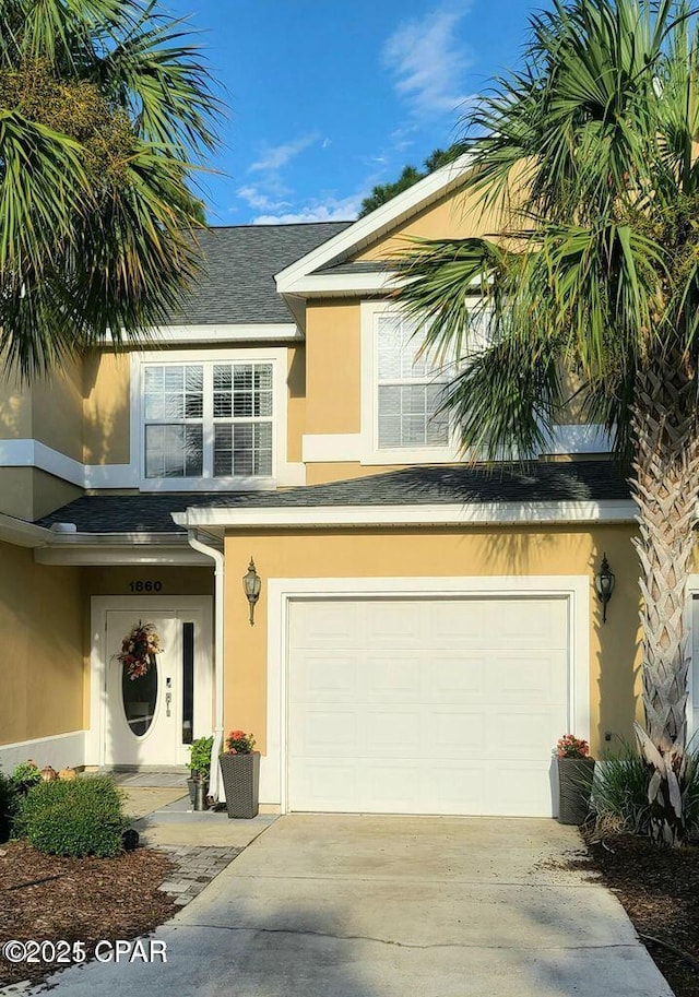 view of front of home featuring driveway, stucco siding, and an attached garage