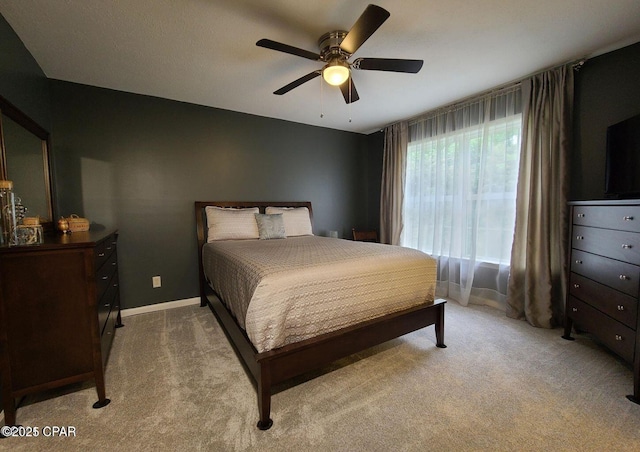 bedroom featuring carpet, baseboards, and ceiling fan