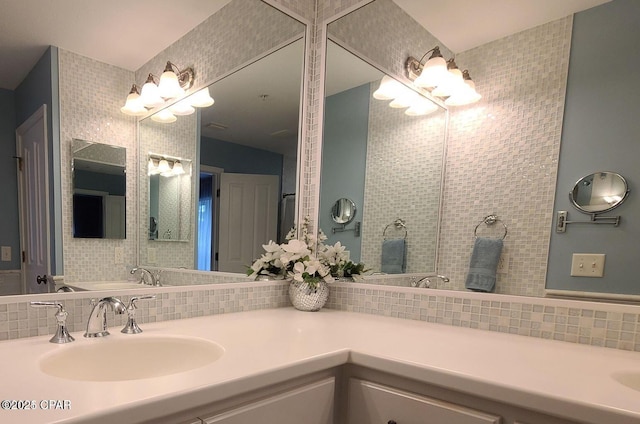 full bath featuring double vanity, a sink, and tasteful backsplash