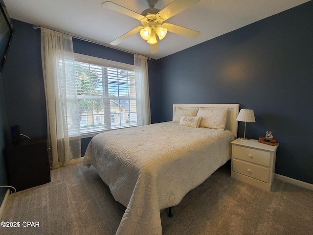 bedroom with baseboards, a ceiling fan, and carpet