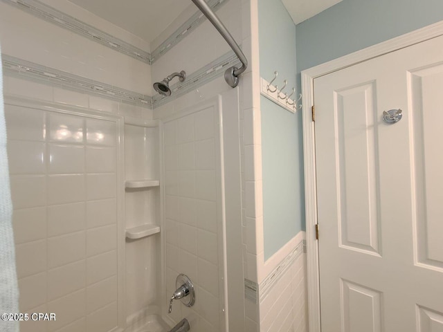 bathroom with tile walls and washtub / shower combination