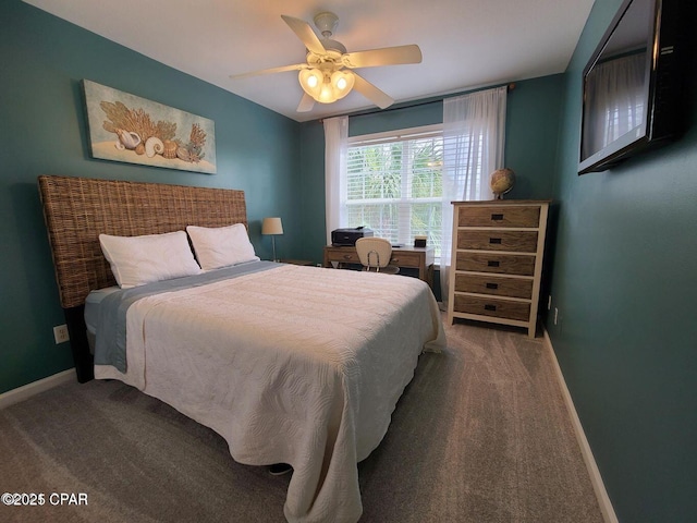 carpeted bedroom featuring baseboards and ceiling fan