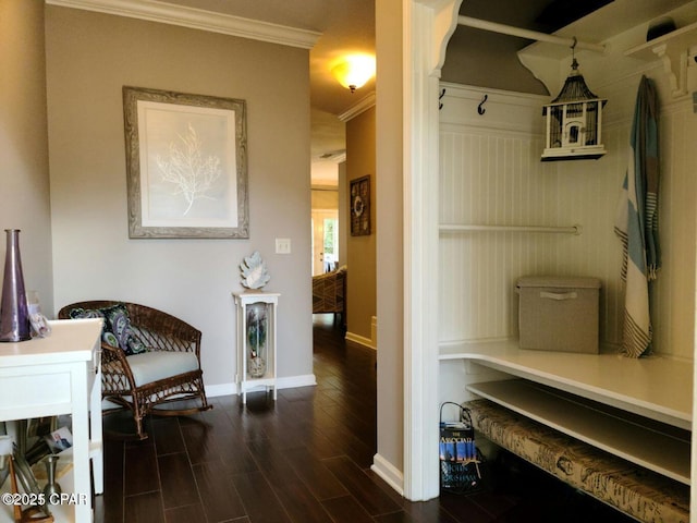mudroom featuring dark wood-type flooring, baseboards, and crown molding