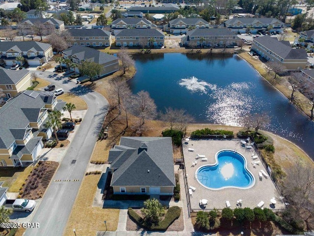drone / aerial view featuring a residential view and a water view
