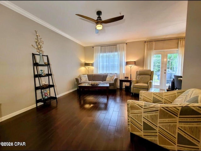 living area featuring a ceiling fan, ornamental molding, baseboards, and wood finished floors
