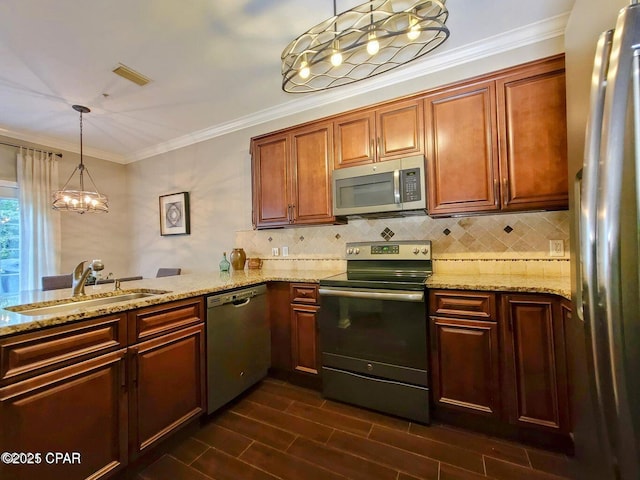 kitchen with crown molding, light stone countertops, stainless steel appliances, a sink, and a notable chandelier