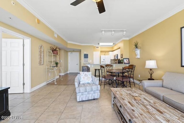 living room featuring light tile patterned floors, baseboards, ceiling fan, ornamental molding, and rail lighting