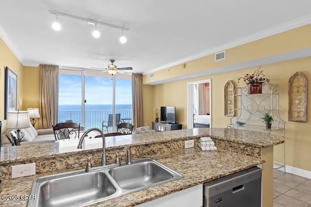 kitchen with visible vents, dishwasher, open floor plan, crown molding, and a sink