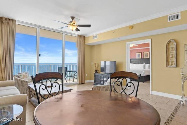 dining space featuring ornamental molding, visible vents, baseboards, and a ceiling fan