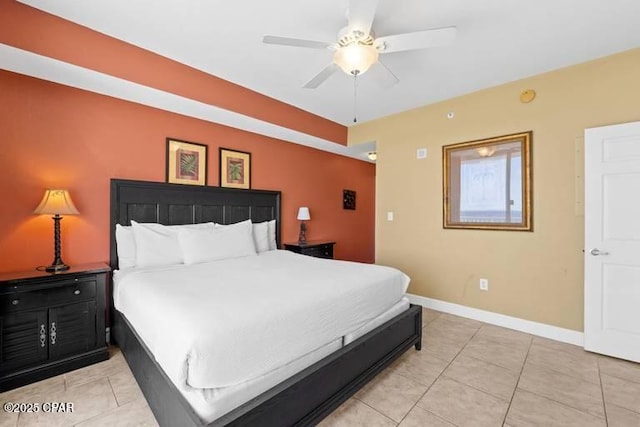 bedroom featuring ceiling fan, light tile patterned flooring, and baseboards