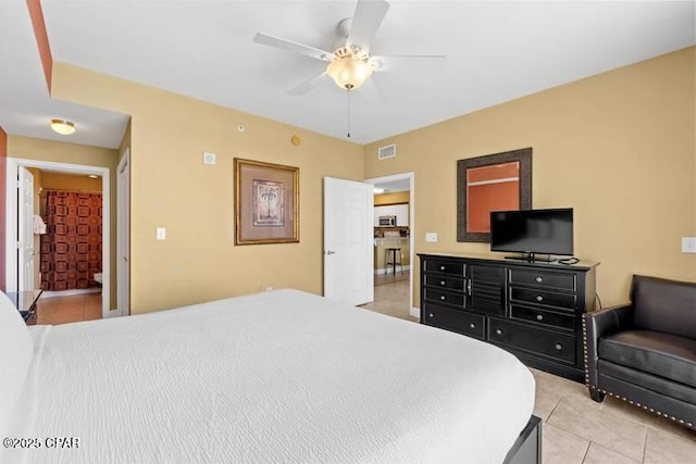 bedroom featuring visible vents, ceiling fan, and light tile patterned floors