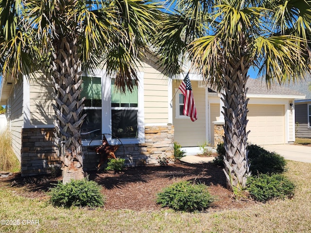 view of property exterior featuring an attached garage and concrete driveway