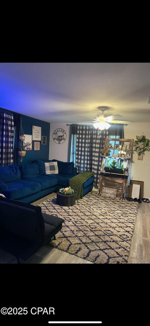 living room with ceiling fan and wood finished floors