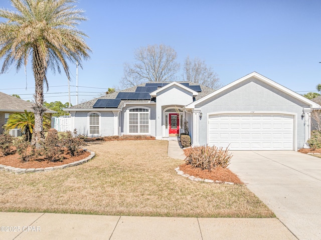 view of front facade featuring an attached garage, solar panels, concrete driveway, stucco siding, and a front lawn