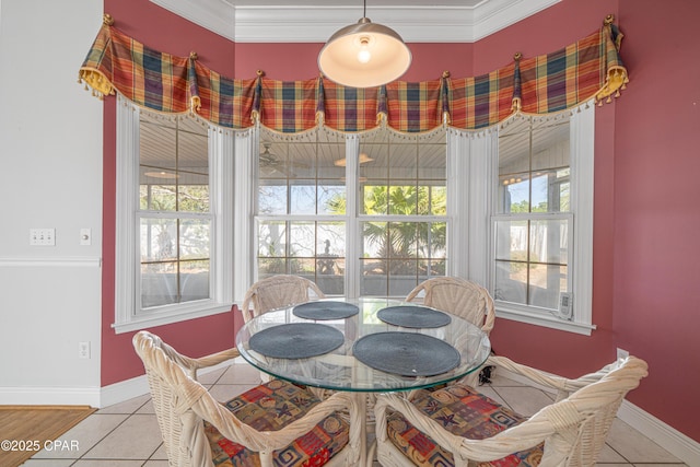 tiled dining area featuring ornamental molding and baseboards