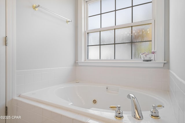 full bathroom featuring a tub with jets