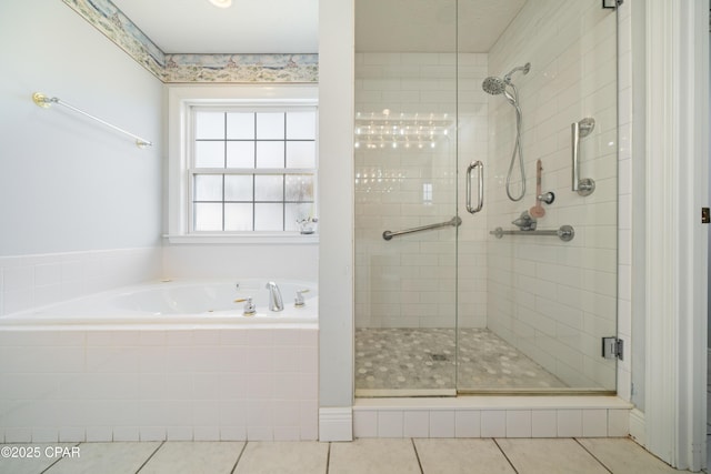 full bathroom featuring tile patterned flooring, a shower stall, and a bath