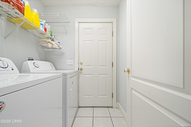 washroom with laundry area, independent washer and dryer, a textured ceiling, and light tile patterned floors