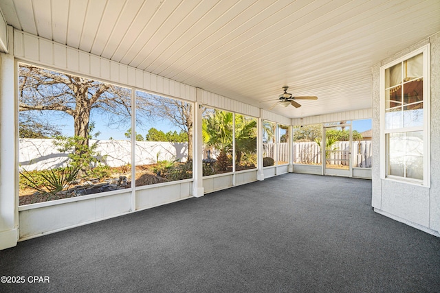 unfurnished sunroom with a ceiling fan