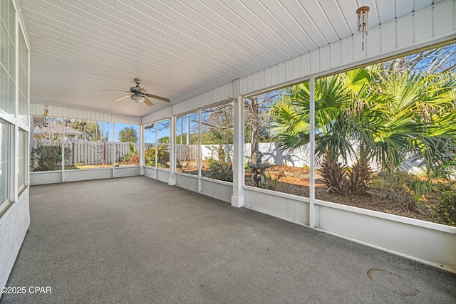 unfurnished sunroom featuring ceiling fan